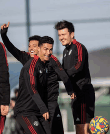 a group of soccer players are playing with a ball