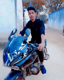 a young man is sitting on a motorcycle with a license plate that says 9h-4331