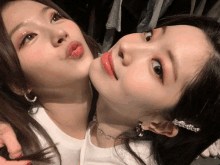 a close up of two women 's faces with one wearing red lipstick