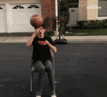 a boy sitting in a chair with a bowl of food and a basketball on his head with the words awesome above him