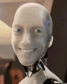 a close up of a robot 's face smiling and looking at the camera .