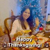 a woman sitting at a table with a plate of food and the words happy thanksgiving written on the bottom