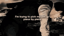 a man is laying on the ground with a quote that says `` i 'm trying to pick myself up piece by piece ''