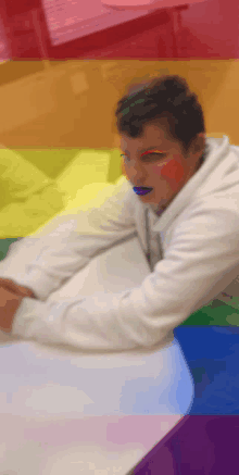 a person with rainbow paint on their face