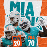 miami dolphins players holding up signs that say den 20 and mia 70