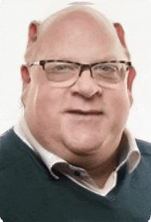 a close up of a man wearing glasses and a blue sweater .