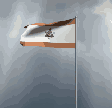 a flag with a poop face on it is flying in the wind