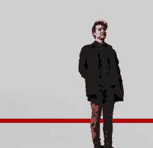 a man in a black coat stands in front of a red line on a white background