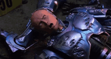 a robot laying on the ground with his mouth open