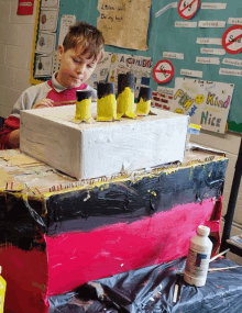 a boy looking at a box that says " fun kind nice "