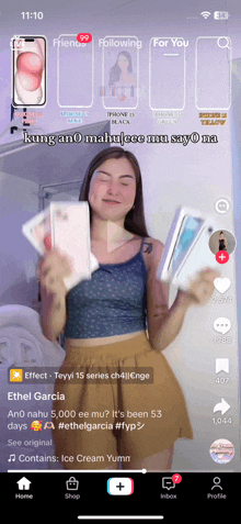 a screenshot of a tiktok app shows a woman holding a cell phone