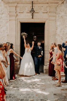 a bride and groom are being congratulated by their wedding guests