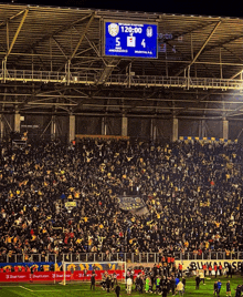 a soccer game is underway and the scoreboard shows that the teams are tied at 5 to 4