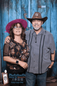 a man and woman pose for a photo in front of a photo booth that says photo booth mirror his memories