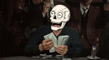 a man with a skull on his head is holding money