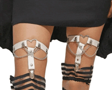 a woman wearing a pair of white leg garters with chains