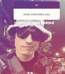 a man wearing a hat and sunglasses has a question about what motivates him