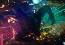 an aerial view of a city at night with a monster flying through the air