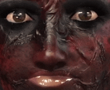 a close up of a person 's face with black paint