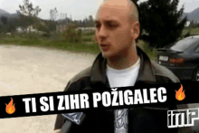 a man is talking into a microphone with a sign that says ti si zihr pozigalec .