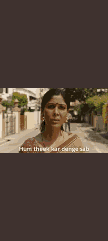 a woman is standing on a street with the words hum theek kar denge sab written below her