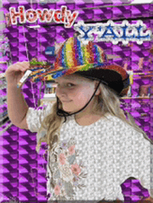 a little girl wearing a colorful cowboy hat stands in front of a sign that says howdy