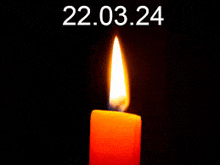 a burning candle with the date 22.03.24 written above it