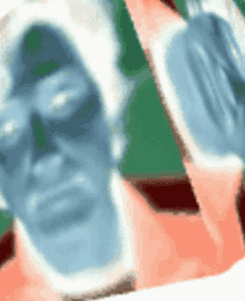 a blurred image of a man 's face with a green background