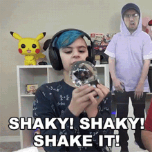 a boy wearing headphones is holding a snow globe with the words shaky shaky shake it