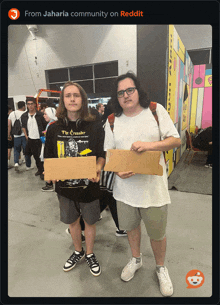 two men holding signs one of which says " i 'm sorry "