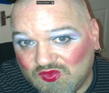 a man with makeup on his face has a picture in picture