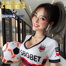 a woman holding a soccer ball with the word sbobet on it