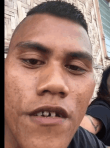 a close up of a man 's face with a few teeth missing