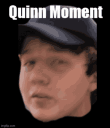 a close up of a person 's face with the words quinn moment written above it