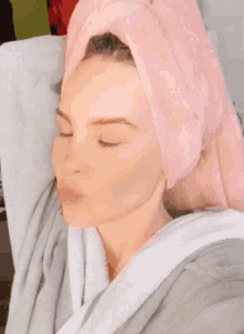 a woman with a pink towel around her head