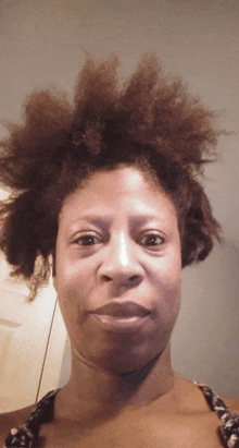 a close up of a woman 's face with her hair in a bun