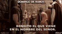 a group of people standing in front of a stone wall with the words bendito el que viene en el nombre del senor