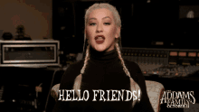 a poster for the addams family shows a woman singing and says hello friends