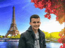 a young man in front of the eiffel tower wearing a black jacket