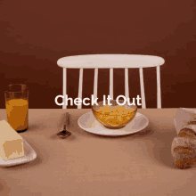 a table with a bowl of cereal a glass of orange juice butter and bread and the words check it out above it