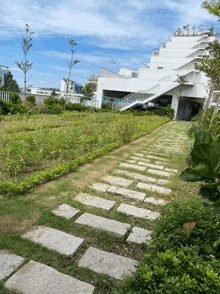 a stone path leads to a building with stairs