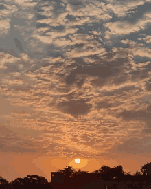 a cloudy sky with the sun shining through it