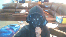 a person wearing a hooded jacket with a mask on their face