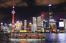 a city skyline at night with a boat in the foreground that says ' happy new year ' on it