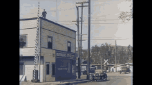 a man stands on top of a building with a sign that says ' northlake 's grocery ' on it