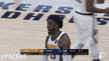 a basketball player with pacers on his jersey celebrates