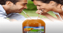 a man and woman drinking through straws next to a jar of juice that says " широкий карамыш "