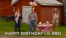 a group of people standing in front of a table with the words happy birthday lil bro written on it