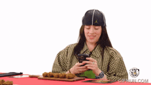 a man and a woman are sitting at a table with a red table cloth and a trophy on top of it