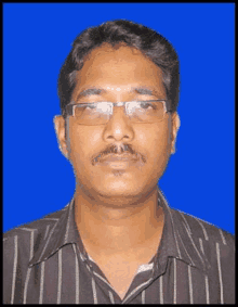 a man wearing glasses and a striped shirt is posing for a picture .